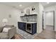 Basement wet bar features patterned tile and beverage fridge at 1317 Spann Ave, Indianapolis, IN 46203