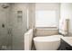 Modern bathroom featuring a soaking tub, sleek glass shower, and elegant fixtures at 13331 Grouse Point Trl, Carmel, IN 46033