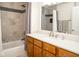 Bathroom featuring a shower and tub combo, vanity and mirror at 13331 Grouse Point Trl, Carmel, IN 46033