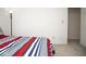 Corner view of a bedroom with striped bedding and a lamp at 13331 Grouse Point Trl, Carmel, IN 46033