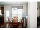 Cozy dining area featuring a round table, wooden chairs, and natural light streaming through the window at 13331 Grouse Point Trl, Carmel, IN 46033