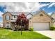 Beautiful two-story brick home with lush lawn, mature red maple, and an attached two-car garage, perfect for Gathering living at 13331 Grouse Point Trl, Carmel, IN 46033