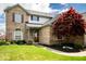 Inviting brick home with a well-maintained lawn, mature shrubs, and a covered front entryway offering classic curb appeal at 13331 Grouse Point Trl, Carmel, IN 46033