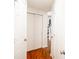 Hallway featuring wood floors, white doors, and access to the staircase at 13331 Grouse Point Trl, Carmel, IN 46033