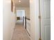 Hallway with carpeted floors and white doors at 13331 Grouse Point Trl, Carmel, IN 46033