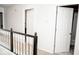 Second floor hallway with views of a bathroom and bedrooms, featuring white trim and neutral carpeting at 13331 Grouse Point Trl, Carmel, IN 46033