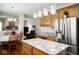 Bright kitchen featuring stainless steel appliances, granite countertops, and wooden cabinets with ample storage at 13331 Grouse Point Trl, Carmel, IN 46033