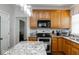 Updated kitchen showcasing granite countertops, cabinetry, and modern appliances at 13331 Grouse Point Trl, Carmel, IN 46033