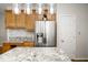 Eat-in kitchen with granite countertops and stainless steel refrigerator at 13331 Grouse Point Trl, Carmel, IN 46033