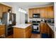 Well-equipped kitchen boasts stainless appliances, granite countertops, a stylish island, and hardwood flooring at 13331 Grouse Point Trl, Carmel, IN 46033