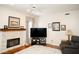 Comfortable living room with stone fireplace, plush seating, and modern entertainment center at 13331 Grouse Point Trl, Carmel, IN 46033