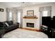 Living room featuring a stone fireplace, and a comfortable seating arrangement with lots of light at 13331 Grouse Point Trl, Carmel, IN 46033