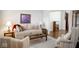 Comfortable living room features a neutral sofa, armchairs, wood accents, and a patterned area rug at 13331 Grouse Point Trl, Carmel, IN 46033