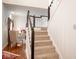 Carpeted staircase with white railings and black posts leading to an open living space at 13331 Grouse Point Trl, Carmel, IN 46033