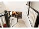 Carpeted staircase with white and black banister leading to an open-concept living space at 13331 Grouse Point Trl, Carmel, IN 46033