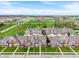 An aerial view of townhomes with brick and siding facades, manicured lawns, and a neighborhood setting at 1352 Middlebury Dr, Westfield, IN 46074
