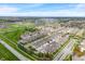 Areal view of townhomes within a planned community, featuring lawns, streets, and natural landscape at 1352 Middlebury Dr, Westfield, IN 46074