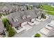 Aerial view of a row of townhomes with red brick, tan siding, rear garages, and fenced patios at 1352 Middlebury Dr, Westfield, IN 46074
