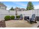 Enjoy this quaint backyard patio with seating for two and privacy fence at 1352 Middlebury Dr, Westfield, IN 46074