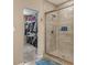 Bathroom featuring a glass shower, tiled walls, blue accents and a view to a spacious walk-in closet at 1352 Middlebury Dr, Westfield, IN 46074