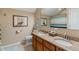 Bathroom showcasing a double sink vanity with granite counters, wood cabinets, and a decorative nautical theme at 1352 Middlebury Dr, Westfield, IN 46074