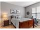 Relaxing bedroom featuring a wooden bed frame with soft bedding, neutral decor, and natural light creating a peaceful retreat at 1352 Middlebury Dr, Westfield, IN 46074