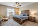 Bright bedroom featuring a wooden bed frame, soft blue bedding, natural light, and a cozy accent chair at 1352 Middlebury Dr, Westfield, IN 46074