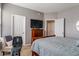 Cozy bedroom with wood-frame bed, soft bedding, and workout equipment, creating a comfortable and functional space at 1352 Middlebury Dr, Westfield, IN 46074
