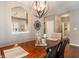 This dining room has a hardwood table and a modern lighting fixture at 1352 Middlebury Dr, Westfield, IN 46074