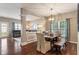 This dining room features hardwood floors, a chandelier, and flows into the living room at 1352 Middlebury Dr, Westfield, IN 46074