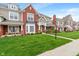 Charming townhouse showcasing brick and siding, a well-maintained lawn, and inviting front porch at 1352 Middlebury Dr, Westfield, IN 46074