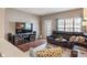 The living room features a leather sofa, a large screen tv, and lots of natural light at 1352 Middlebury Dr, Westfield, IN 46074