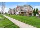 Attractive townhomes lining a street with green lawns, sidewalks, and young trees at 1352 Middlebury Dr, Westfield, IN 46074