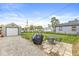 Well-manicured backyard with patio and a detached garage at 1412 Wallace Ave, Indianapolis, IN 46201