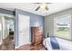A sunlit bedroom with a wood dresser and comfortable bed at 1412 Wallace Ave, Indianapolis, IN 46201