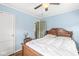 Comfortable bedroom features wood-style flooring, a ceiling fan, and an inviting bed at 1412 Wallace Ave, Indianapolis, IN 46201