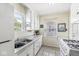 Functional kitchen featuring a double sink, white cabinets, and ample countertop space at 1412 Wallace Ave, Indianapolis, IN 46201