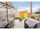 Cozy backyard with seating, grill, and bright yellow shed at 1453 English Ave, Indianapolis, IN 46201