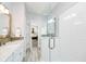 Bathroom featuring a vanity, a glass shower, and a view into the bedroom at 1453 English Ave, Indianapolis, IN 46201