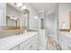 Bathroom featuring double vanity, a large mirror, and glass enclosed walk-in shower at 1453 English Ave, Indianapolis, IN 46201