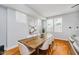 Elegant dining room featuring hardwood floors, modern table, and lots of natural light at 1453 English Ave, Indianapolis, IN 46201