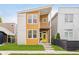 Modern two-story home featuring a yellow front door, second-story balcony, and manicured front lawn at 1453 English Ave, Indianapolis, IN 46201