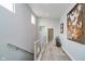 Hallway with a carpeted floor, a handrail, and artwork hanging on the wall at 1453 English Ave, Indianapolis, IN 46201