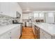 Modern kitchen with white cabinets, stainless steel appliances, and mosaic backsplash at 1453 English Ave, Indianapolis, IN 46201