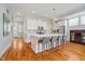 Bright kitchen with white cabinetry, a large island with seating, and wood flooring at 1453 English Ave, Indianapolis, IN 46201