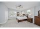 Main bedroom featuring a ceiling fan, a dresser, and large windows with blinds at 1453 English Ave, Indianapolis, IN 46201