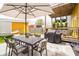 Outdoor patio area with dining table, grill, and shaded seating at 1453 English Ave, Indianapolis, IN 46201