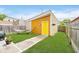 Backyard shed with yellow door at 1453 English Ave, Indianapolis, IN 46201