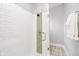 Modern shower with white subway tile, a rainfall showerhead, and a glass door at 1453 English Ave, Indianapolis, IN 46201