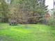 Lush backyard featuring a mature tree, green grass and a picnic table; perfect for outdoor enjoyment at 14544 Lynn Ave, Fishers, IN 46038